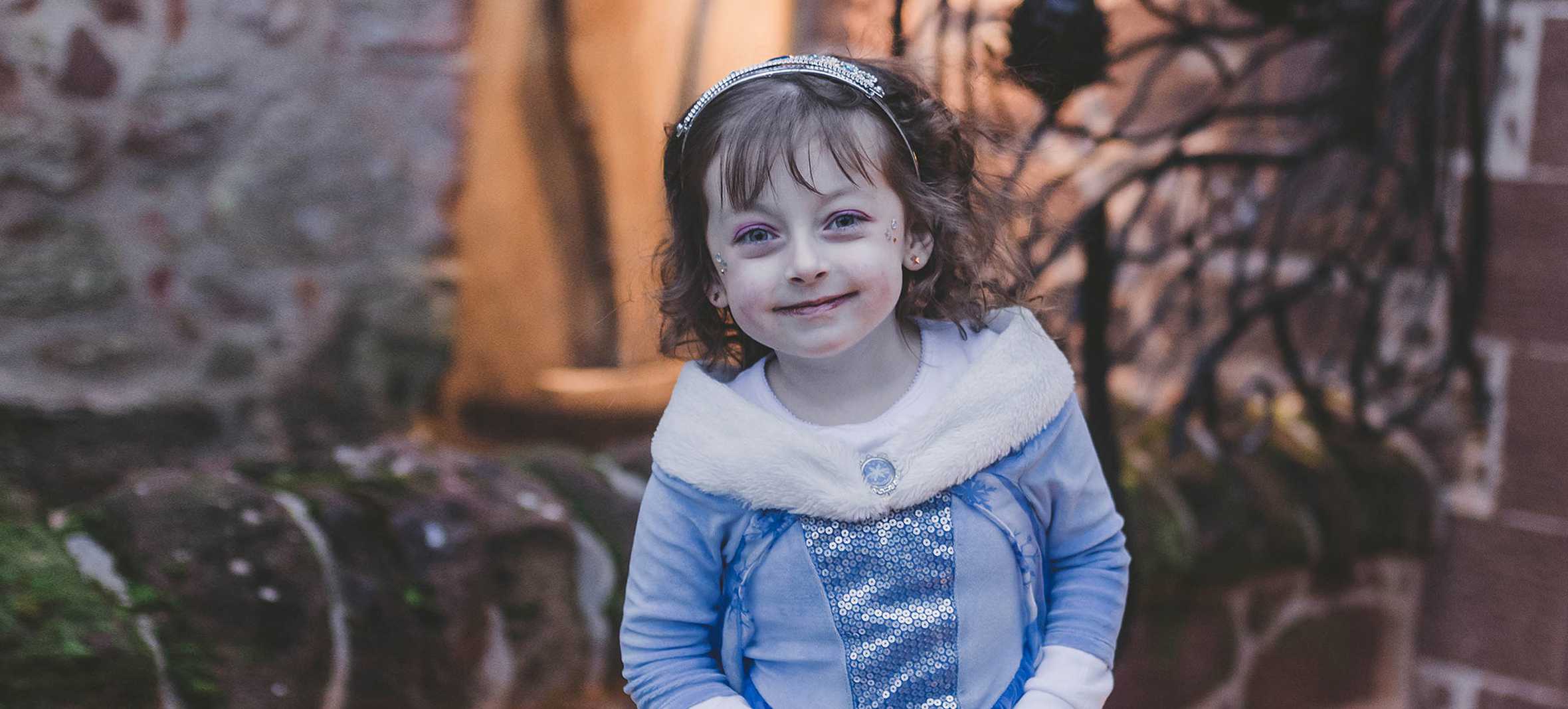 Wish child, Alyssia dressed in a blue princess dress and tiara.