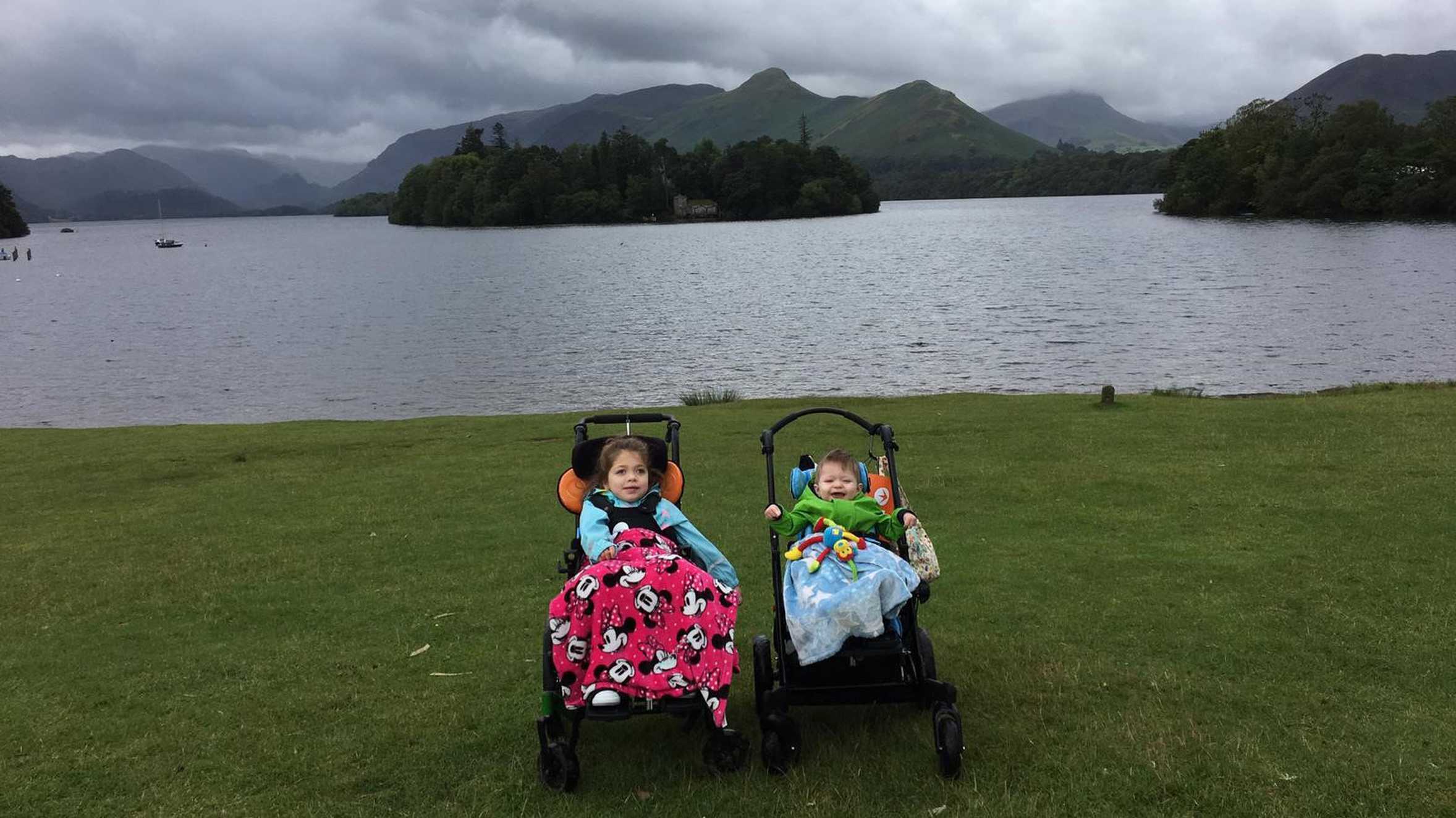 Aubree and her brother on the lake shore with the stunning Lake District scenery in the background.